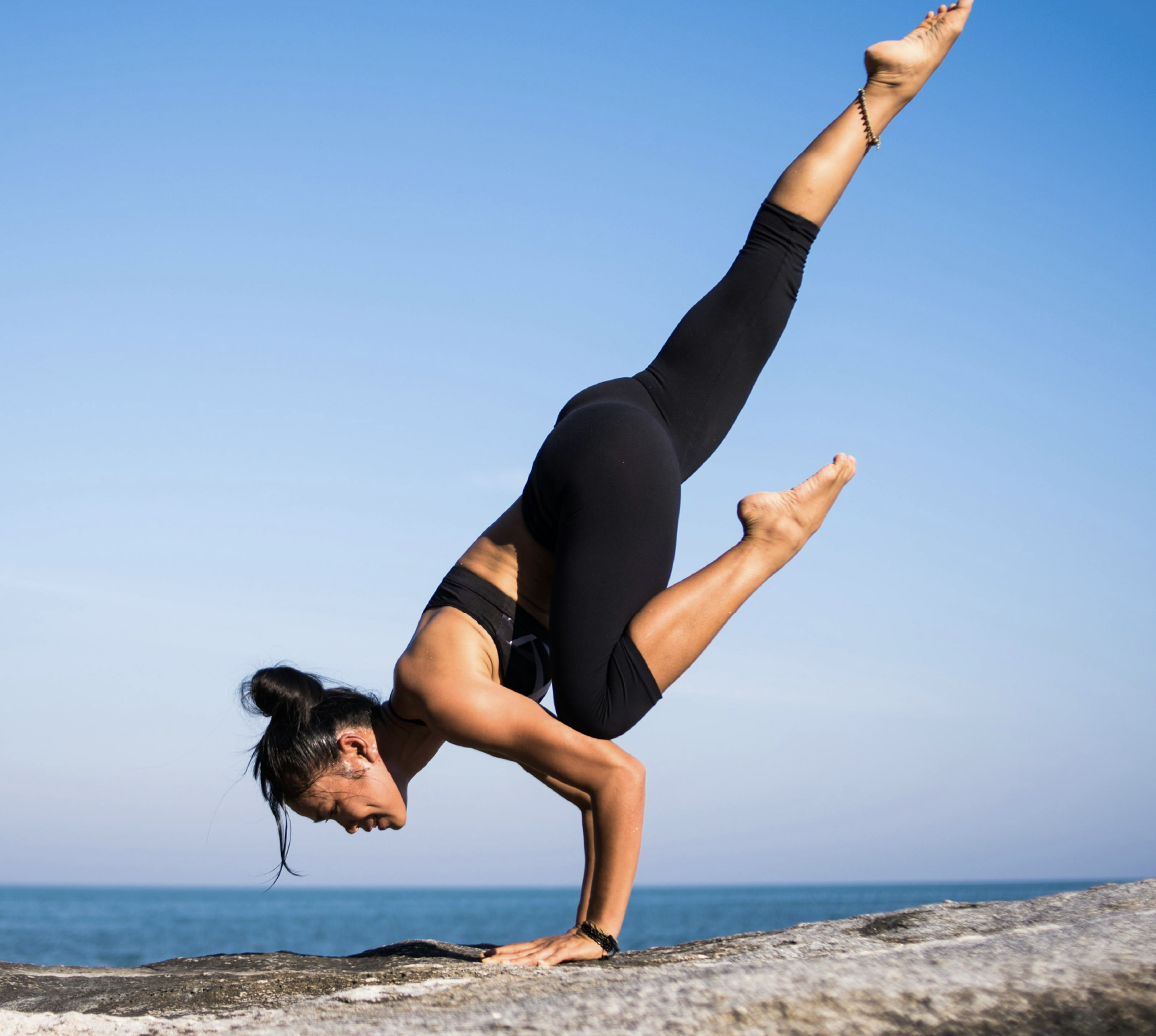 Women doing yoga at the beach