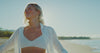 Trūspan protocol. Video of a happy woman on a beach enjoying life.